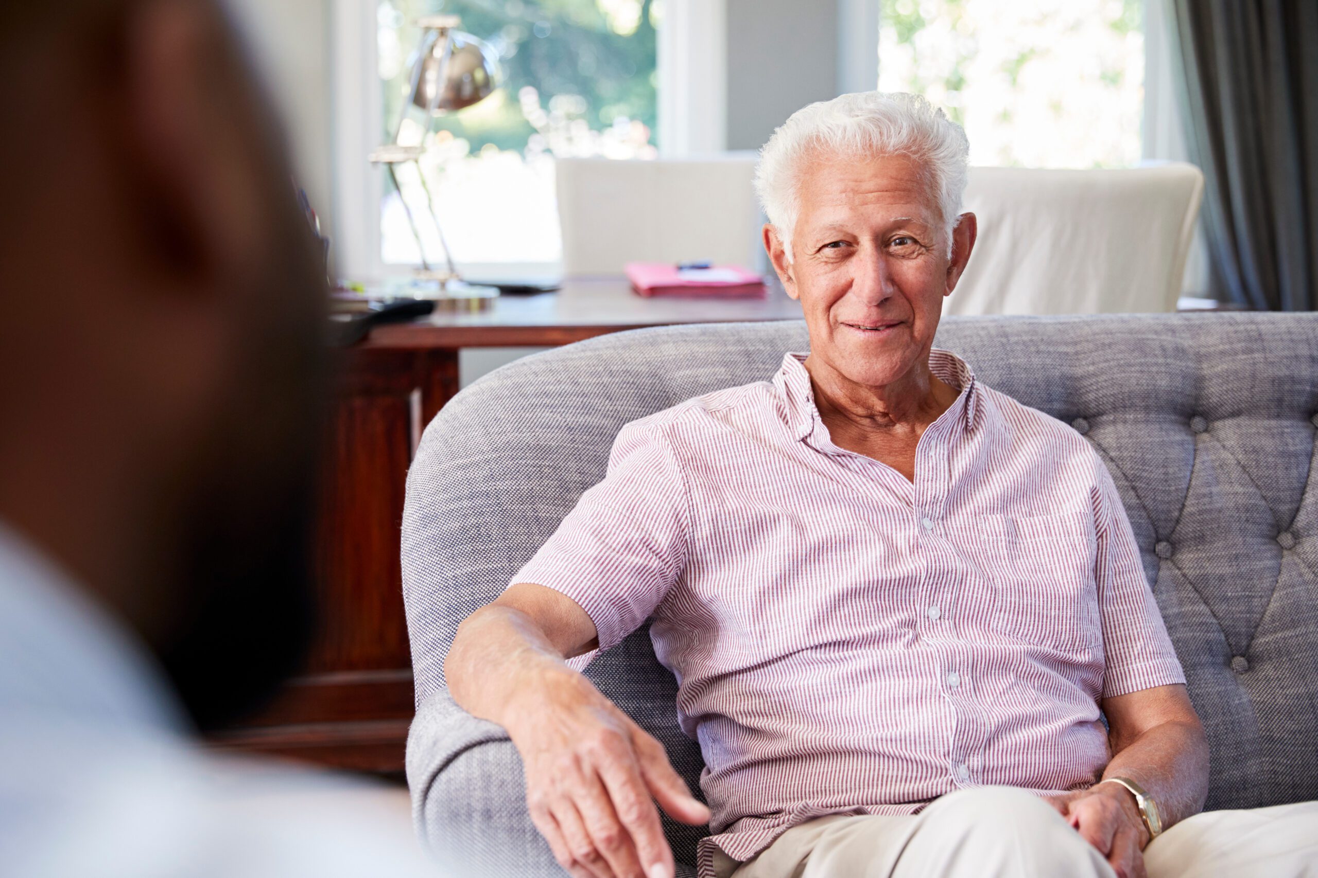 Happy senior man taking financial advice at home