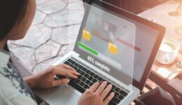 Transfer files data system relocation concept, Person hand using laptop computer waiting for transfer file process with loading bar icon on virtual screen....