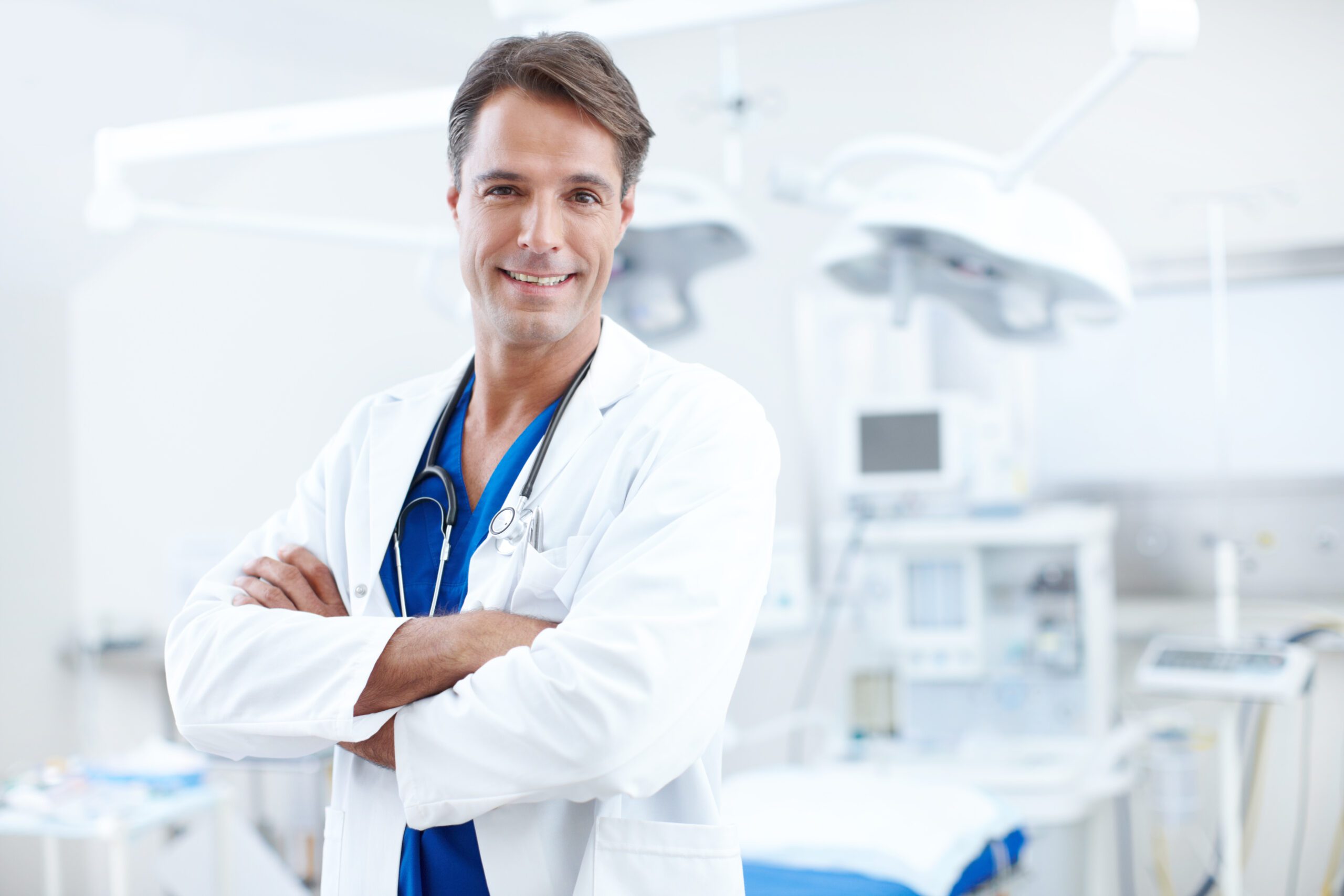 Hes very professional and great at what he does. Close-up of a confident male doctor standing with his arms crossed in the hospital.